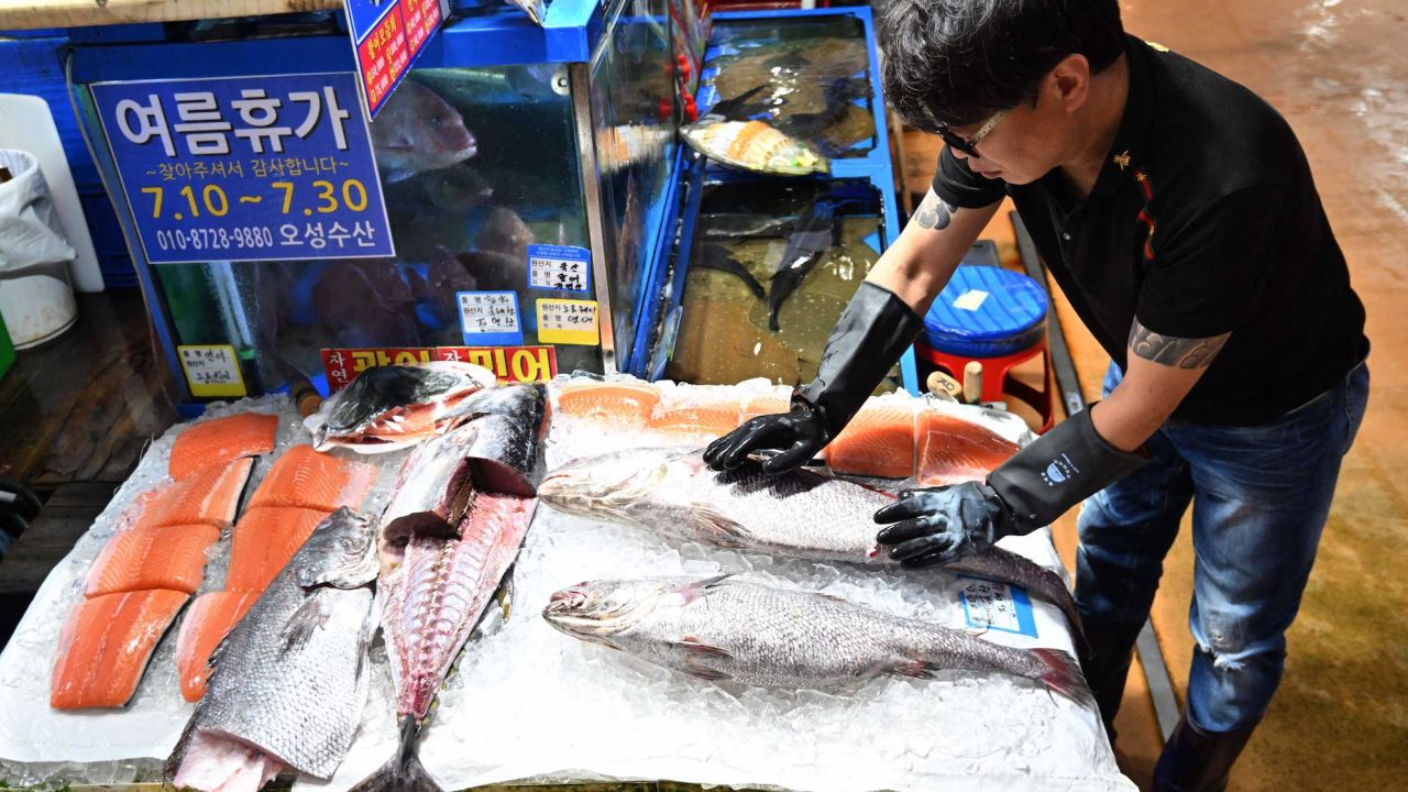 A fishmonger arranges seafood at the Noryangjin Fisheries Wholesale Market in Seoul on July 6, 2023.