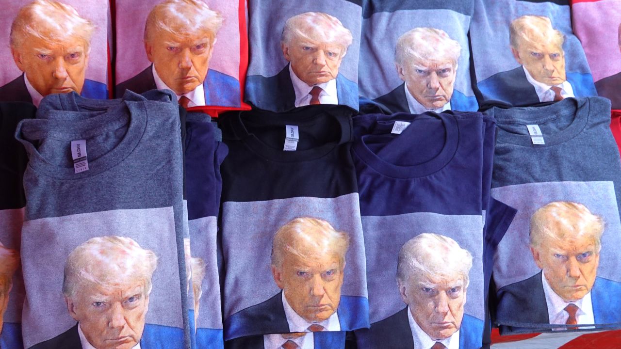 A vendor sells T-shirts featuring Trump's mug shot outside his Rapid City, South Dakota, rally on September 8, 2023.