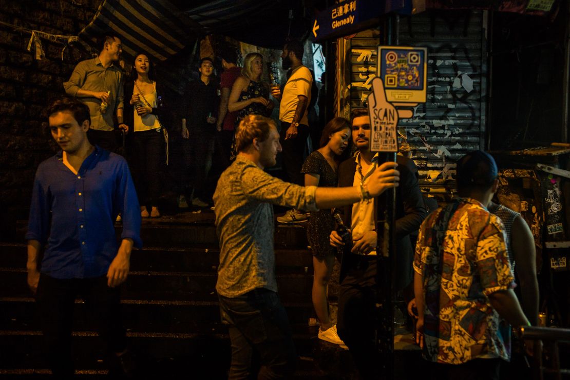 People stand and drink in Lan Kwai Fong in 2017, back when the place was still pumping.